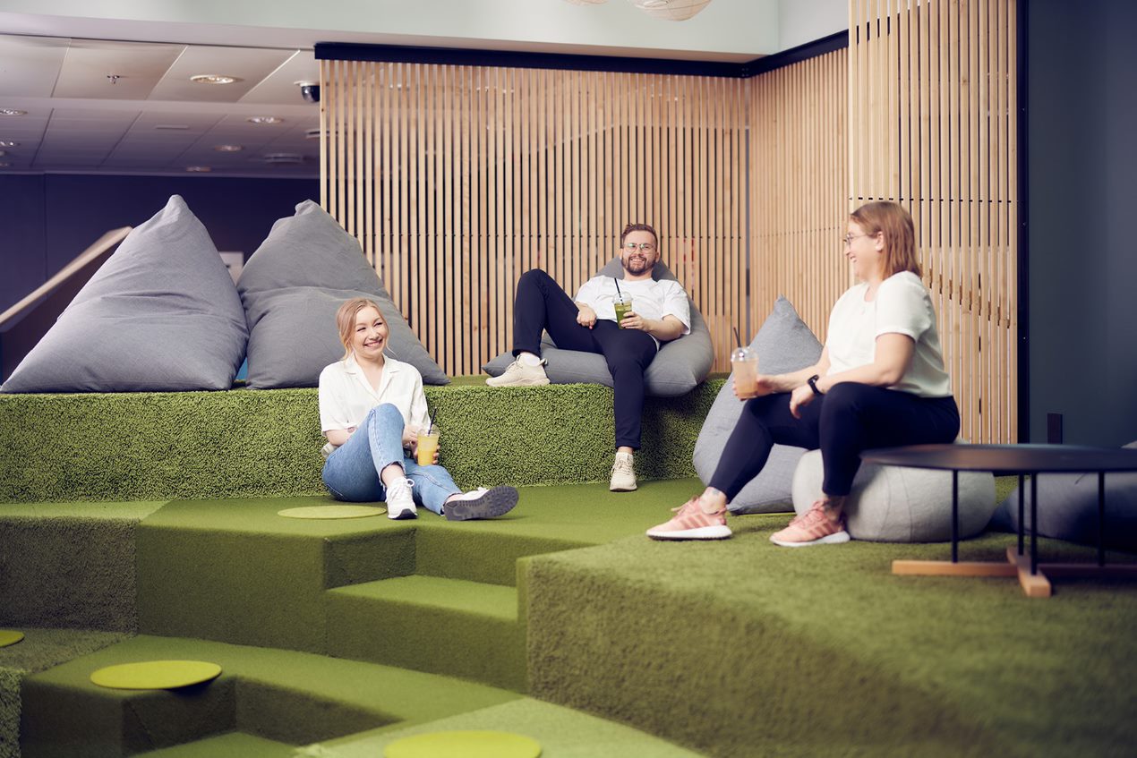 Image of three people at a break in the office in Finland