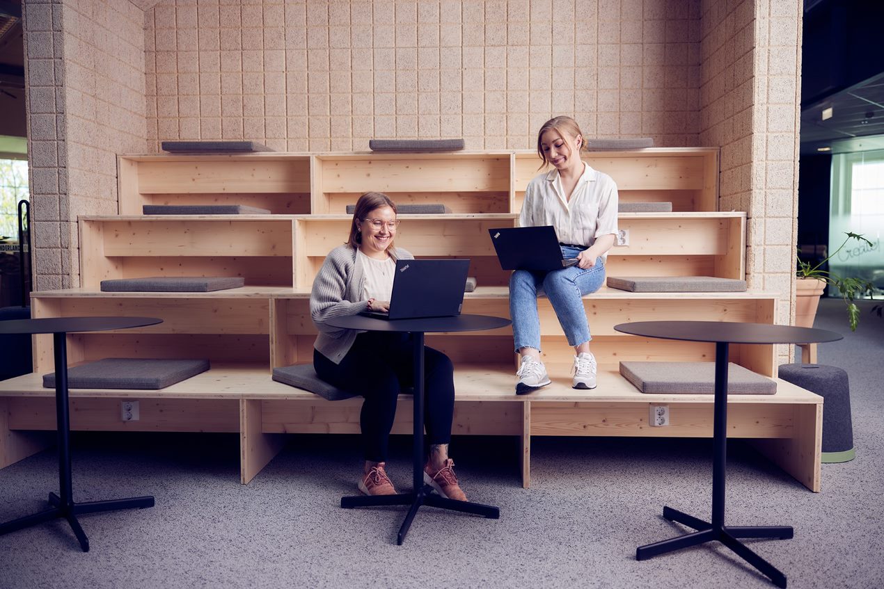 Image of two persons preparing their CVs in front of their laptops